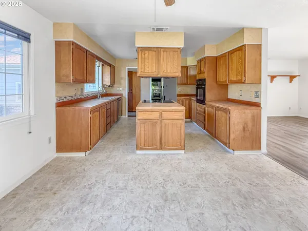 a large kitchen with cabinets and stainless steel appliances
