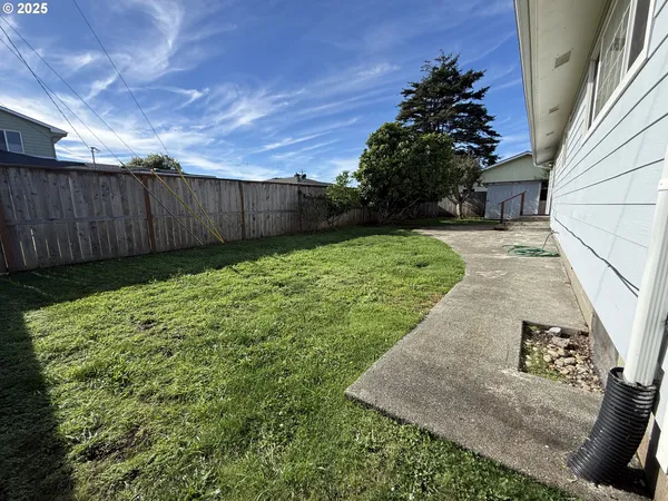 a view of backyard of house with green space