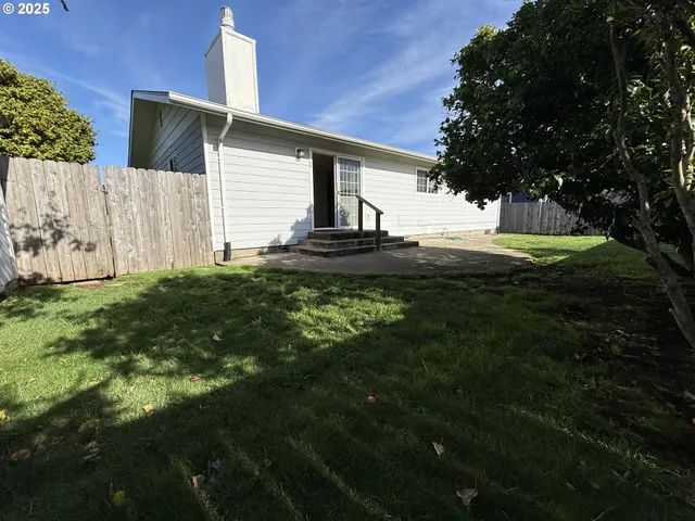 a view of a backyard with a tree