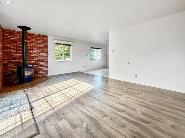 wooden floor in an empty room with windows