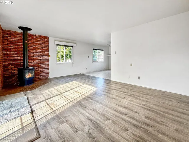 wooden floor in an empty room with windows