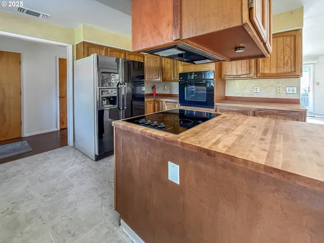 a kitchen that has a refrigerator and a stove