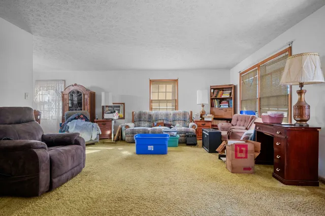 a view of a dining room with furniture and chandelier