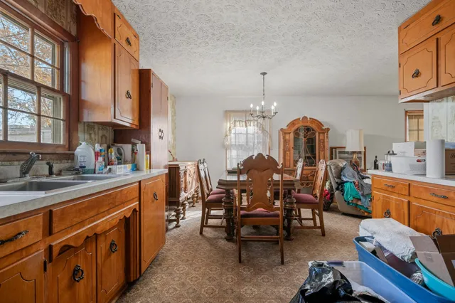 a living room with furniture floor to ceiling window and a flat screen tv
