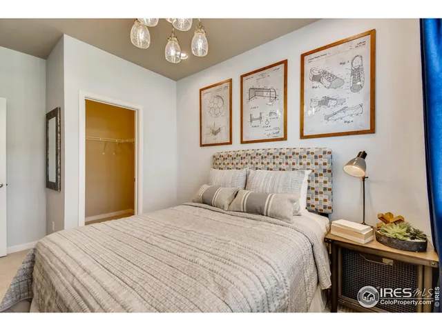 a bedroom with a bed and a painting on the wall