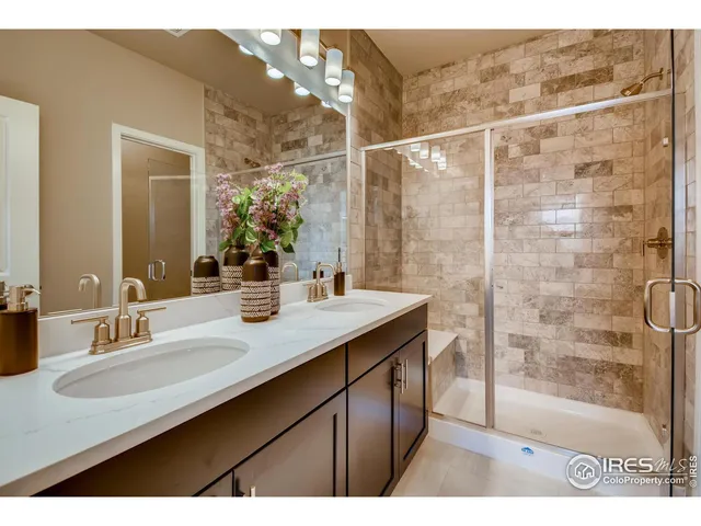 a bathroom with a sink mirror and a shower