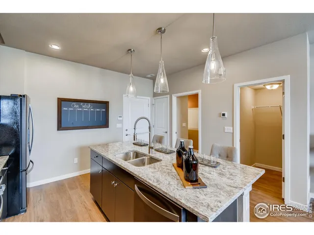a kitchen with sink cabinets and chandelier