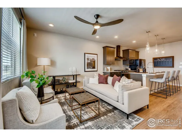 a living room with furniture kitchen and a chandelier