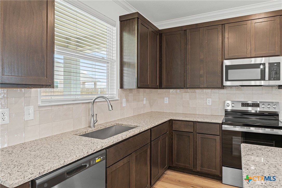 7810 Timber Holw Lane Temple, TX 76502 - Photo 16 of 32 a kitchen with a sink and cabinets