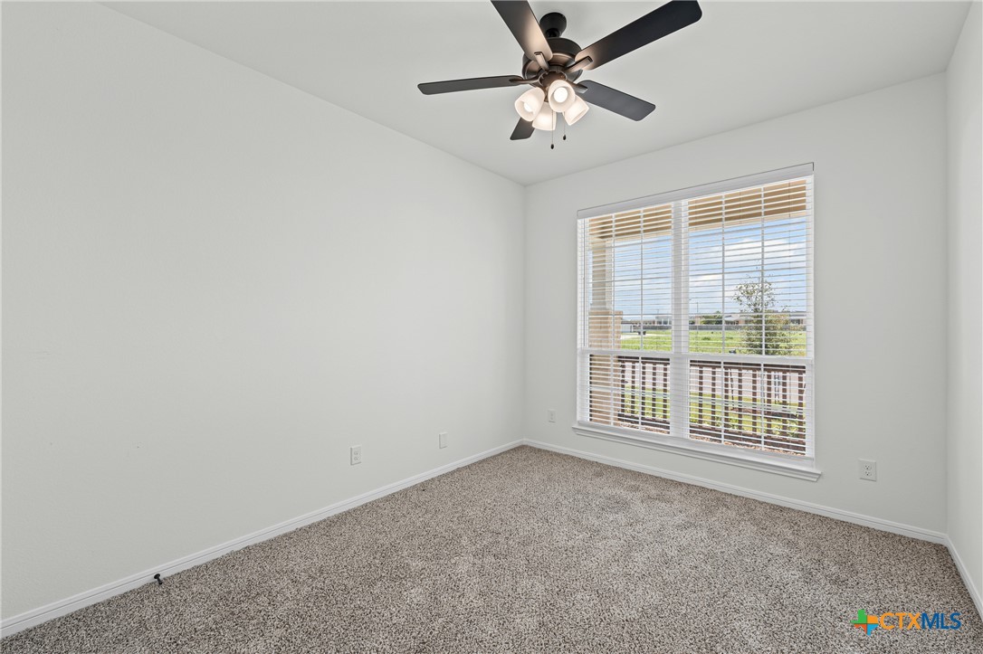 7810 Timber Holw Lane Temple, TX 76502 - Photo 7 of 32 an empty room with windows and fan