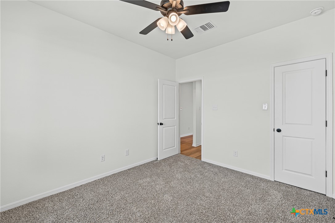 7810 Timber Holw Lane Temple, TX 76502 - Photo 8 of 32 a view of an empty room and chandelier fan
