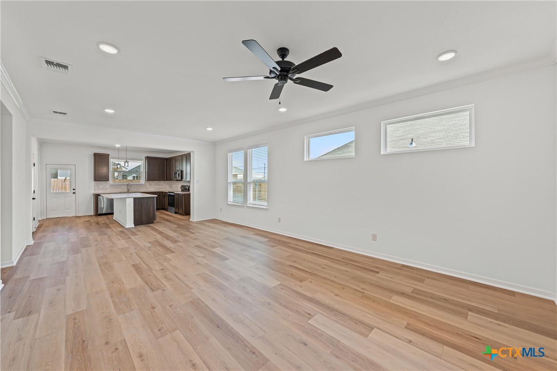 7810 Timber Holw Lane Temple, TX 76502 - Photo 9 of 32 a view of a livingroom with a ceiling fan a ceiling fan and wooden floor