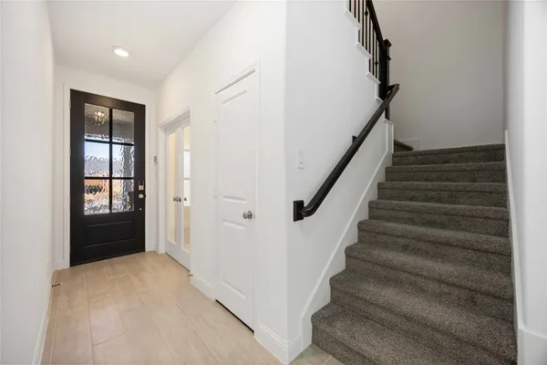 a view of entryway and hall with wooden floor