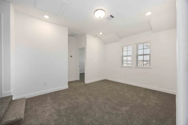 an empty room with windows and closet