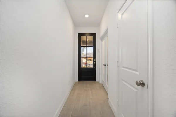 a view of a hallway with wooden shelves