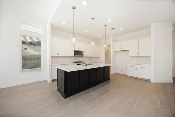a kitchen with kitchen island cabinets and window
