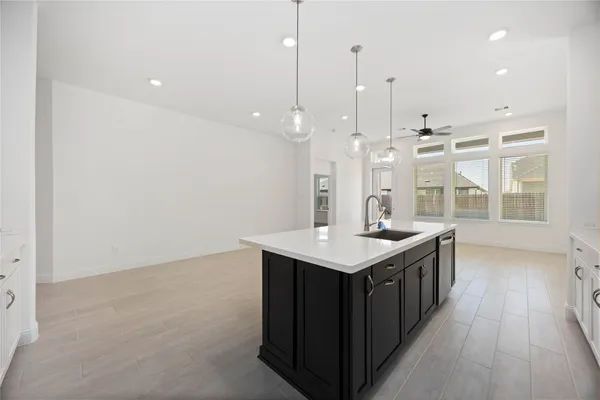 a kitchen with a stove and a wooden floor