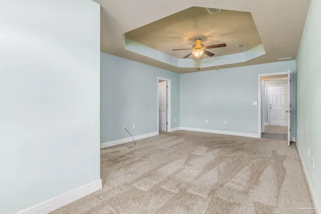 an empty room with a ceiling fan