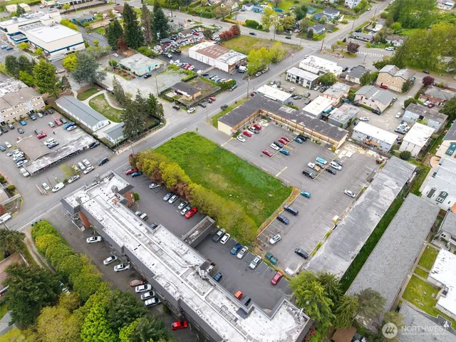 an aerial view of a house with a garden and lake view