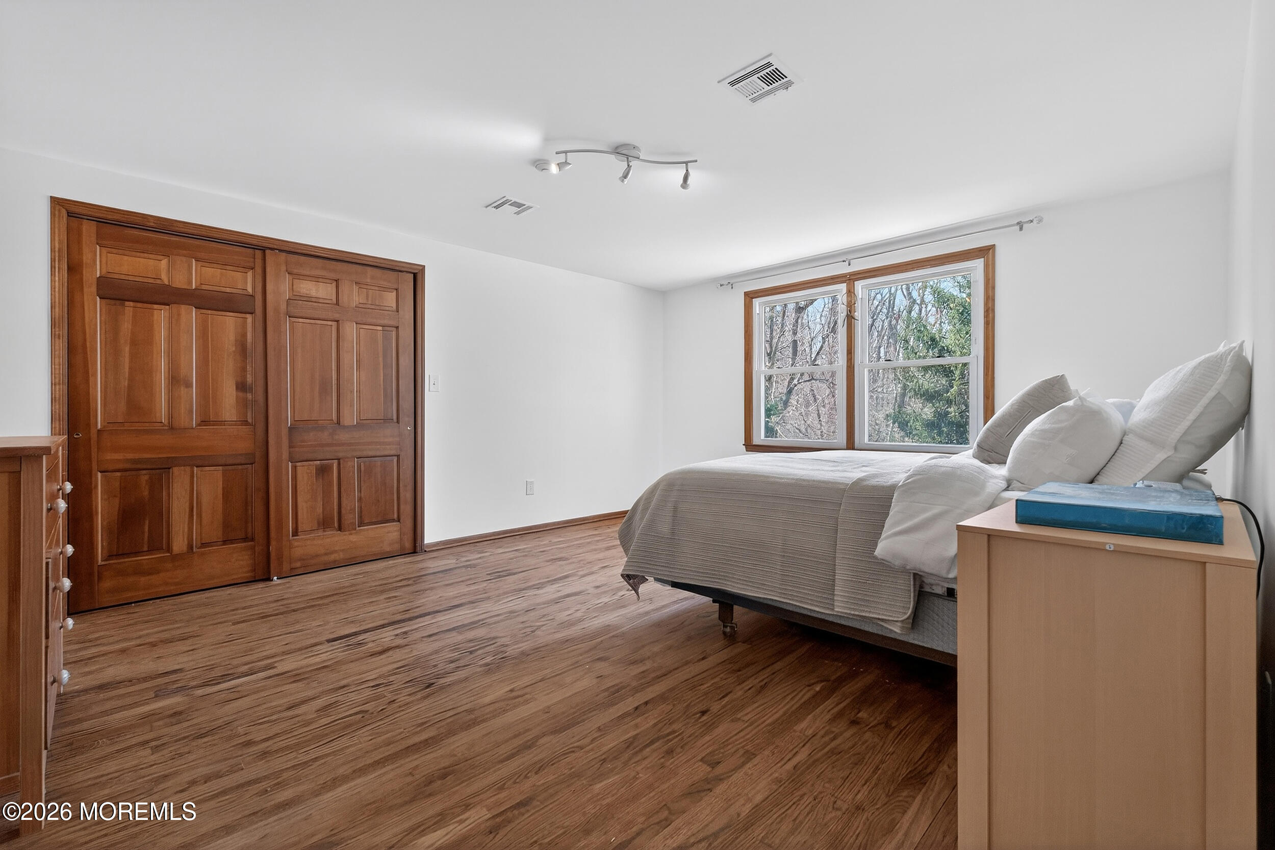 76 Telegraph Hill Road Holmdel, NJ 07733 - Photo 26 of 51 a bedroom with a bed and wooden floor