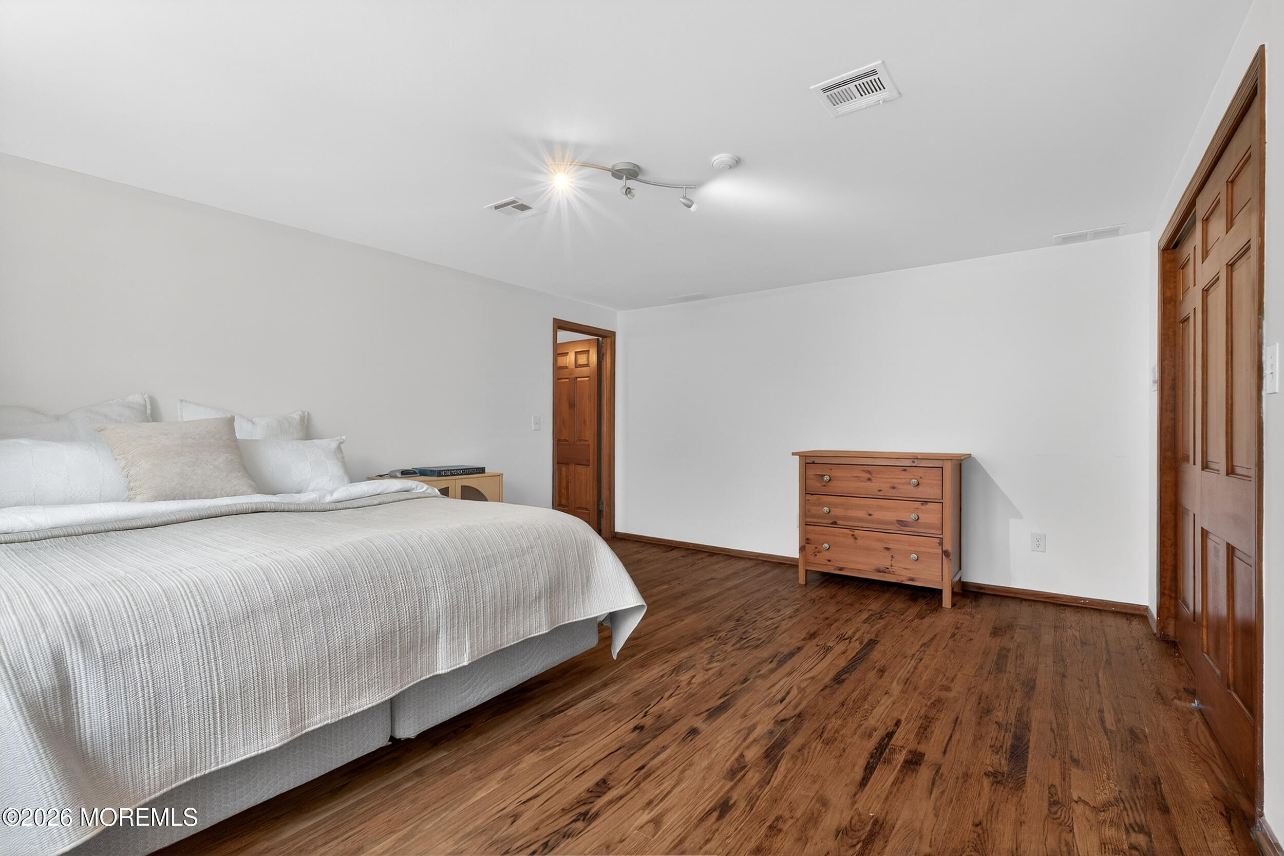 76 Telegraph Hill Road Holmdel, NJ 07733 - Photo 29 of 51 a bedroom with a bed and wooden floor