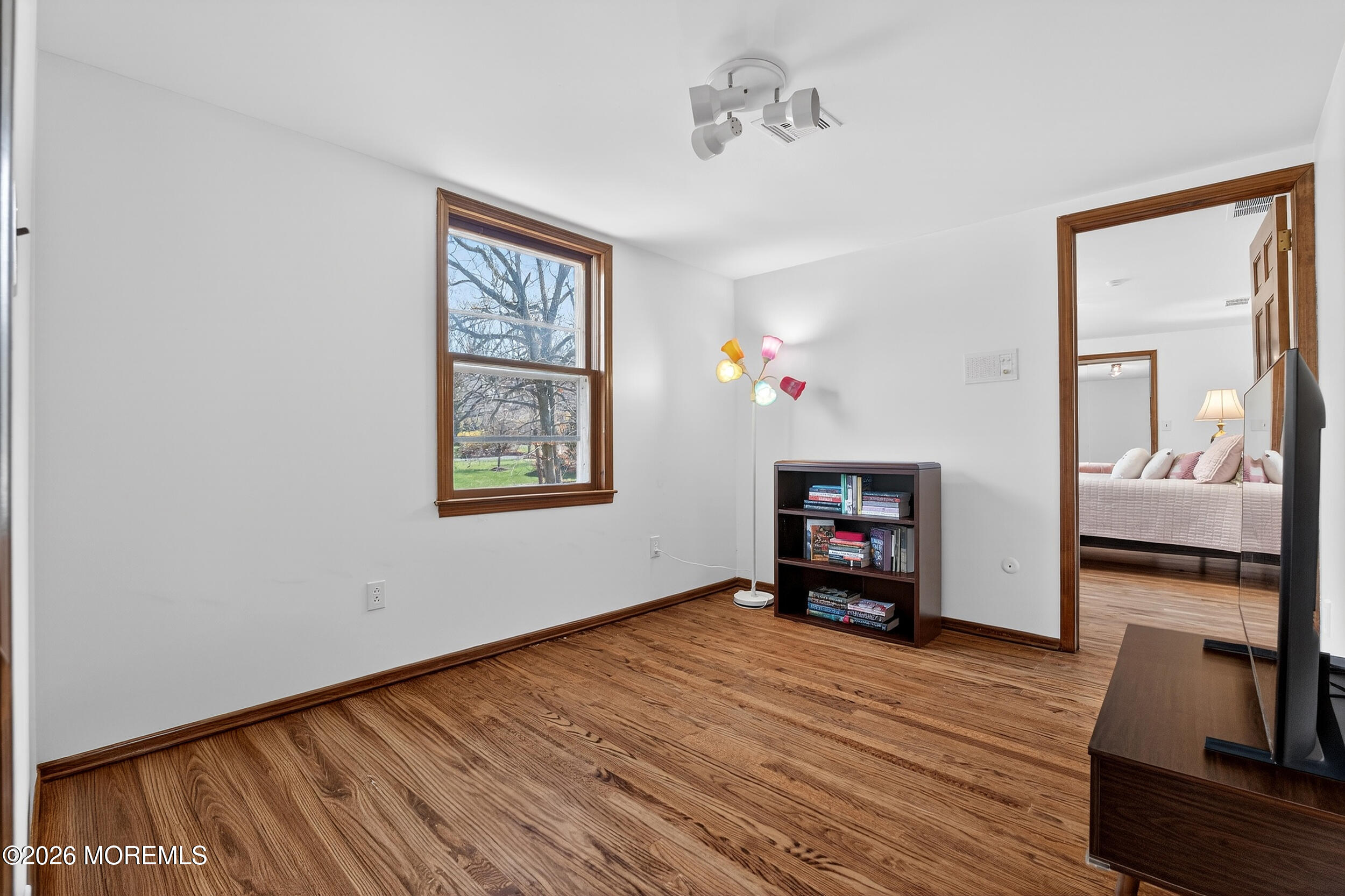 76 Telegraph Hill Road Holmdel, NJ 07733 - Photo 35 of 51 a view of an empty room with wooden floor fireplace and a window