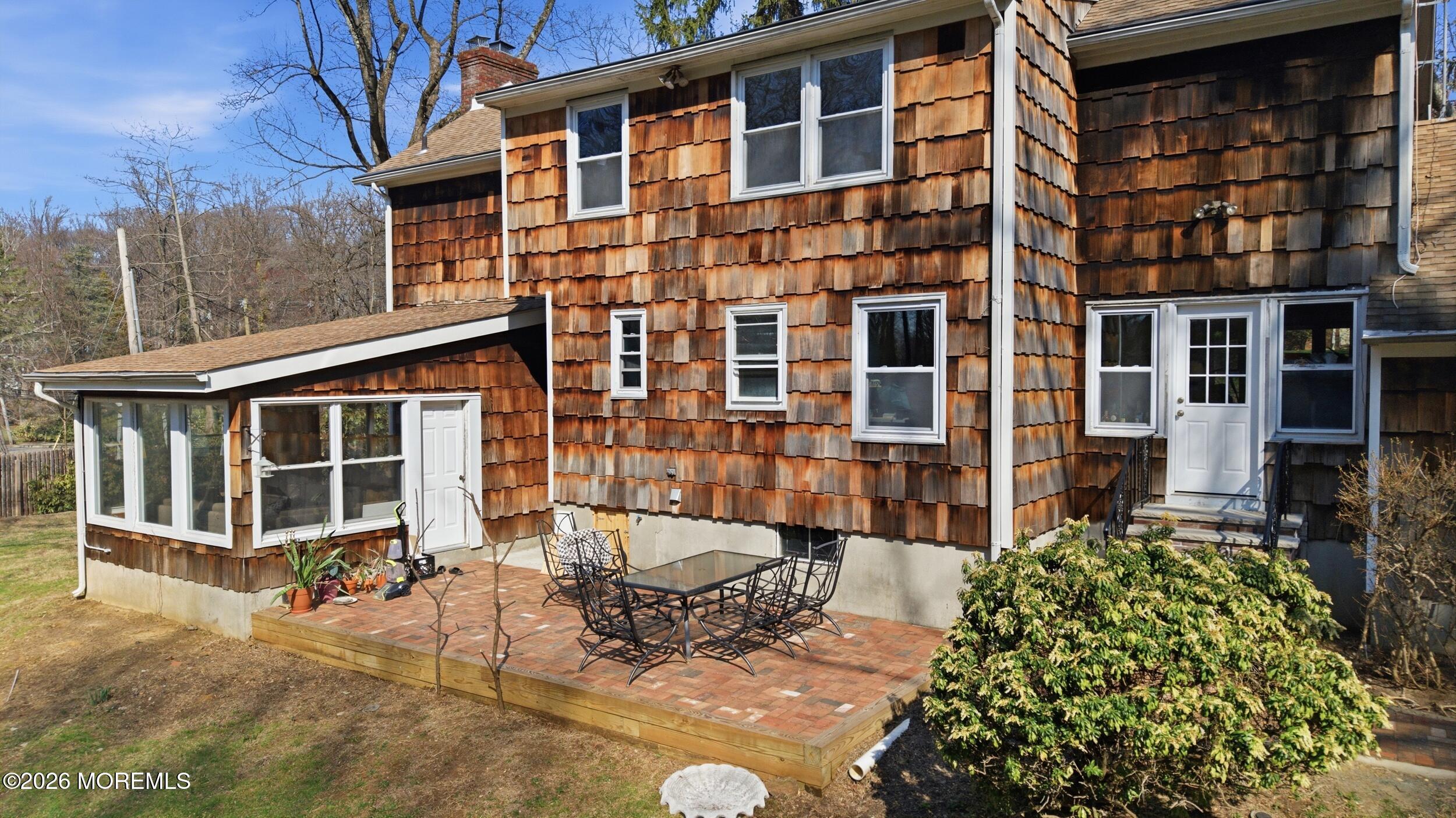 76 Telegraph Hill Road Holmdel, NJ 07733 - Photo 43 of 51 front view of a house with a large window and potted plants