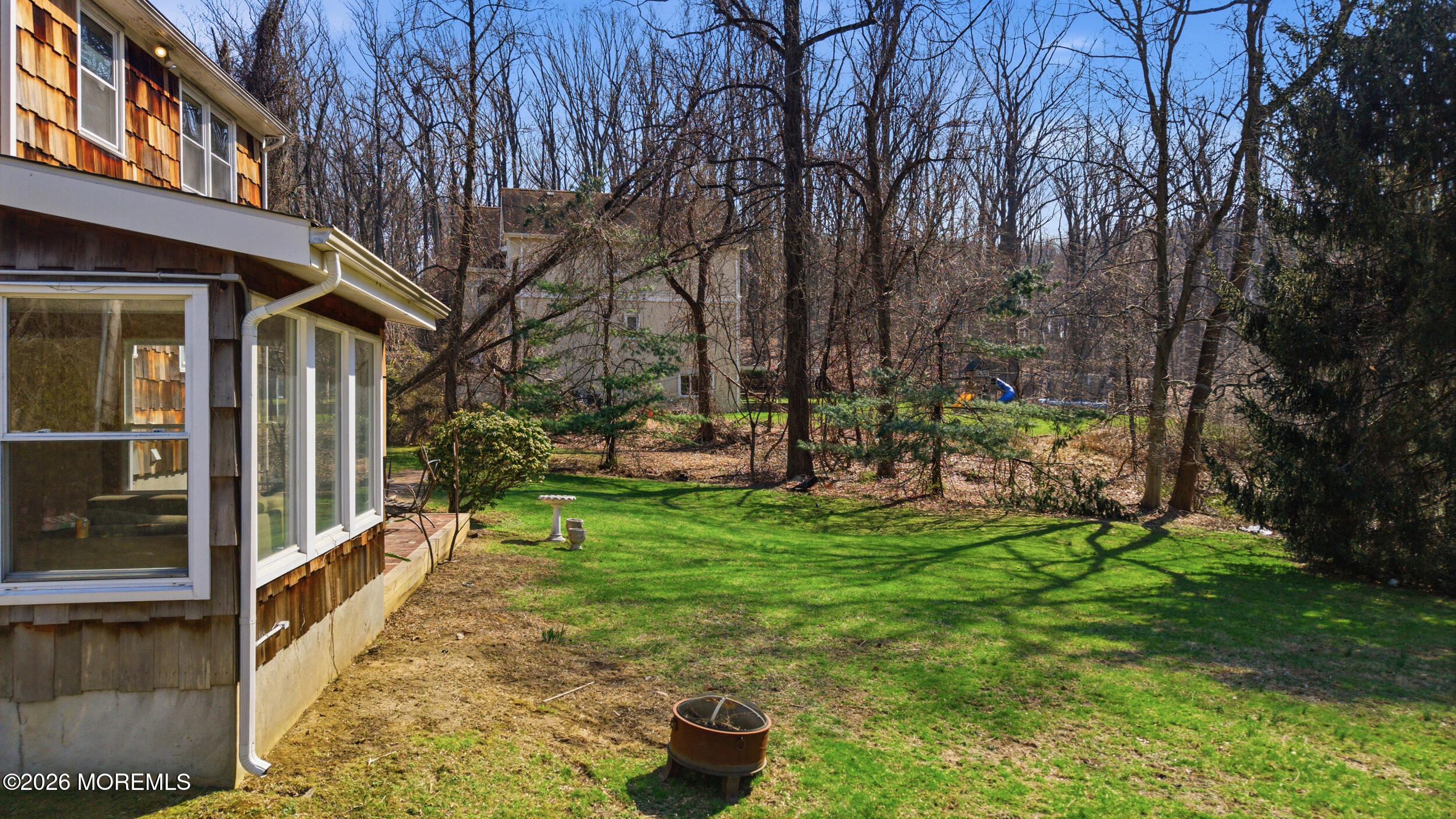 76 Telegraph Hill Road Holmdel, NJ 07733 - Photo 44 of 51 a view of a chair and tables in the patio next to a yard