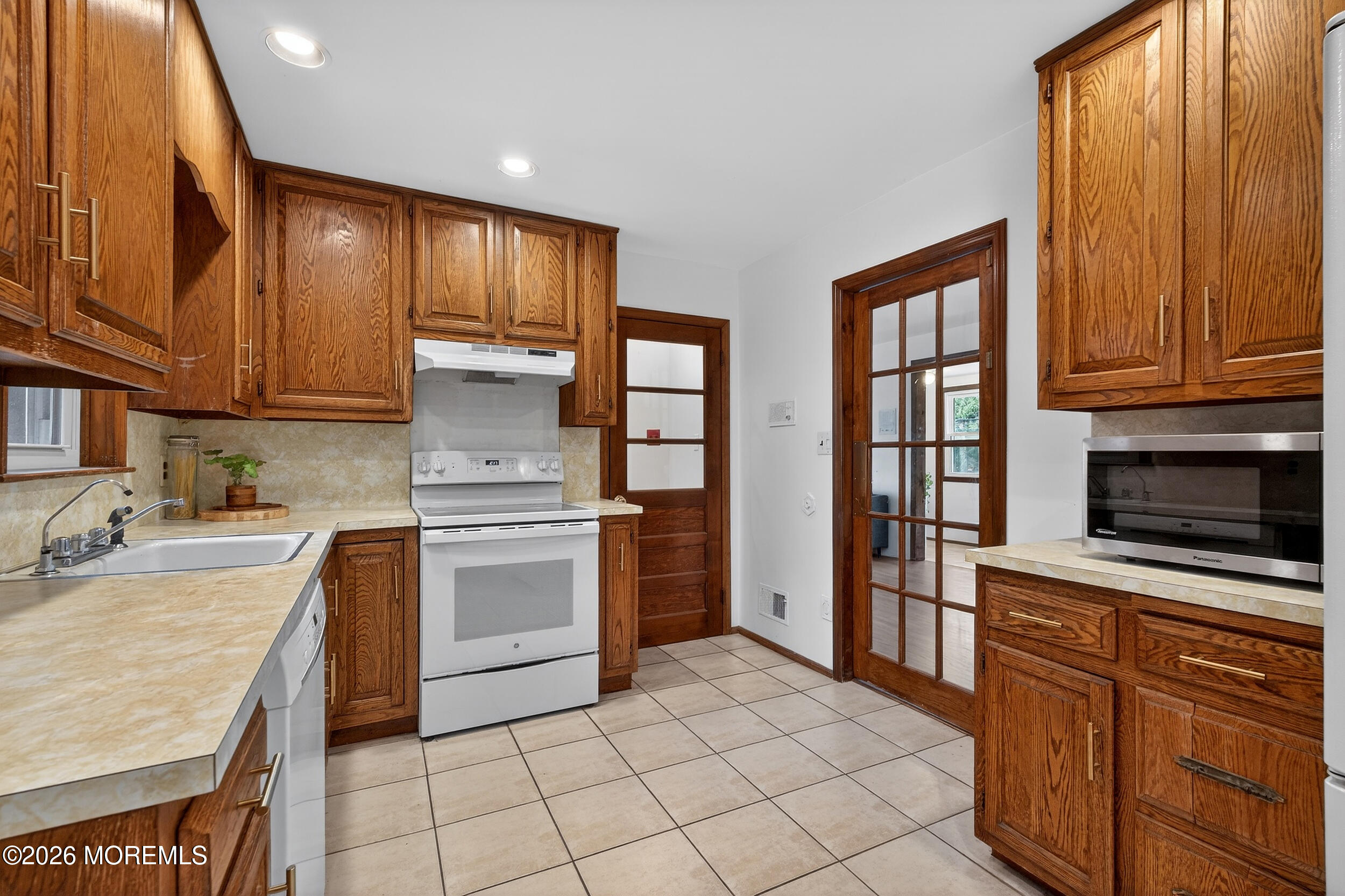 76 Telegraph Hill Road Holmdel, NJ 07733 - Photo 8 of 51 a kitchen with stainless steel appliances granite countertop a stove a sink and a microwave