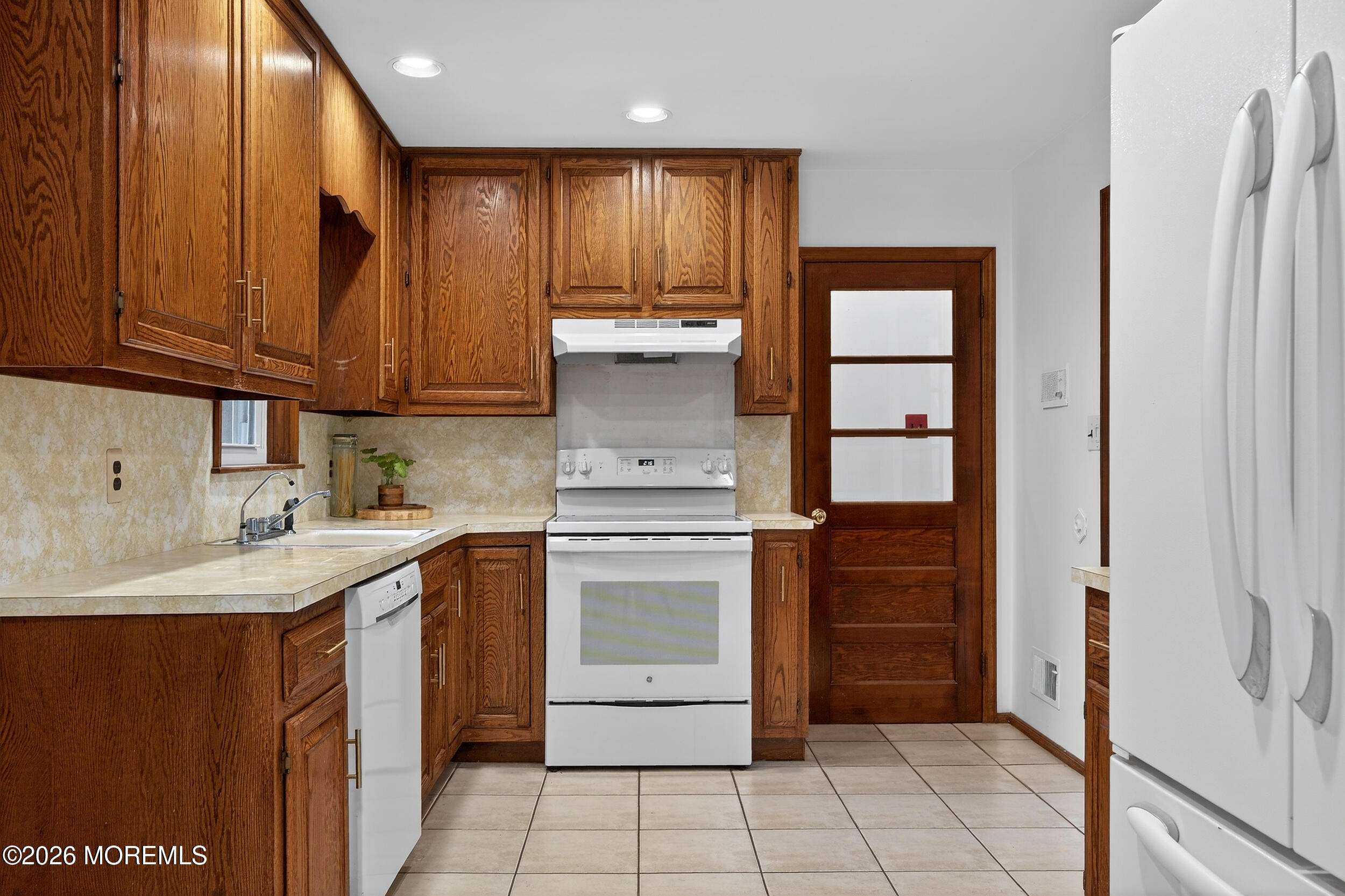 76 Telegraph Hill Road Holmdel, NJ 07733 - Photo 10 of 51 a kitchen with a stove sink and cabinets