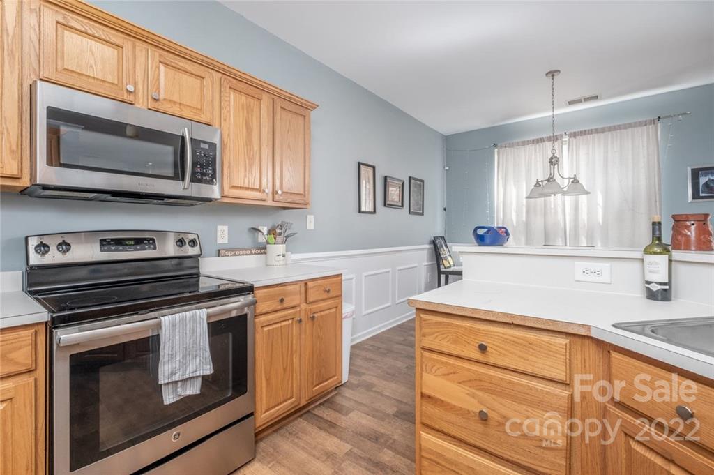 8010 Trotter Road Charlotte, NC 28216 - Photo 11 of 42 a kitchen with stainless steel appliances granite countertop a stove microwave and sink