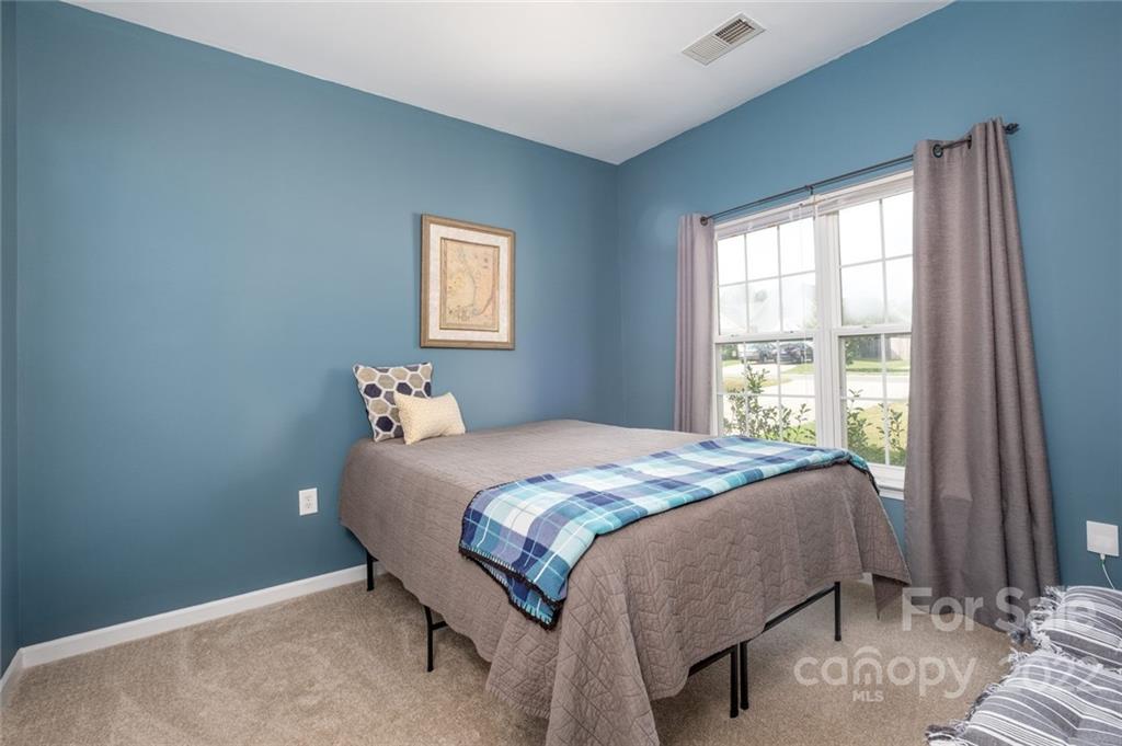 8010 Trotter Road Charlotte, NC 28216 - Photo 12 of 42 a bedroom with a bed and a window
