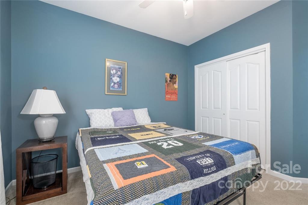 8010 Trotter Road Charlotte, NC 28216 - Photo 15 of 42 a bedroom with a bed a rug and a window