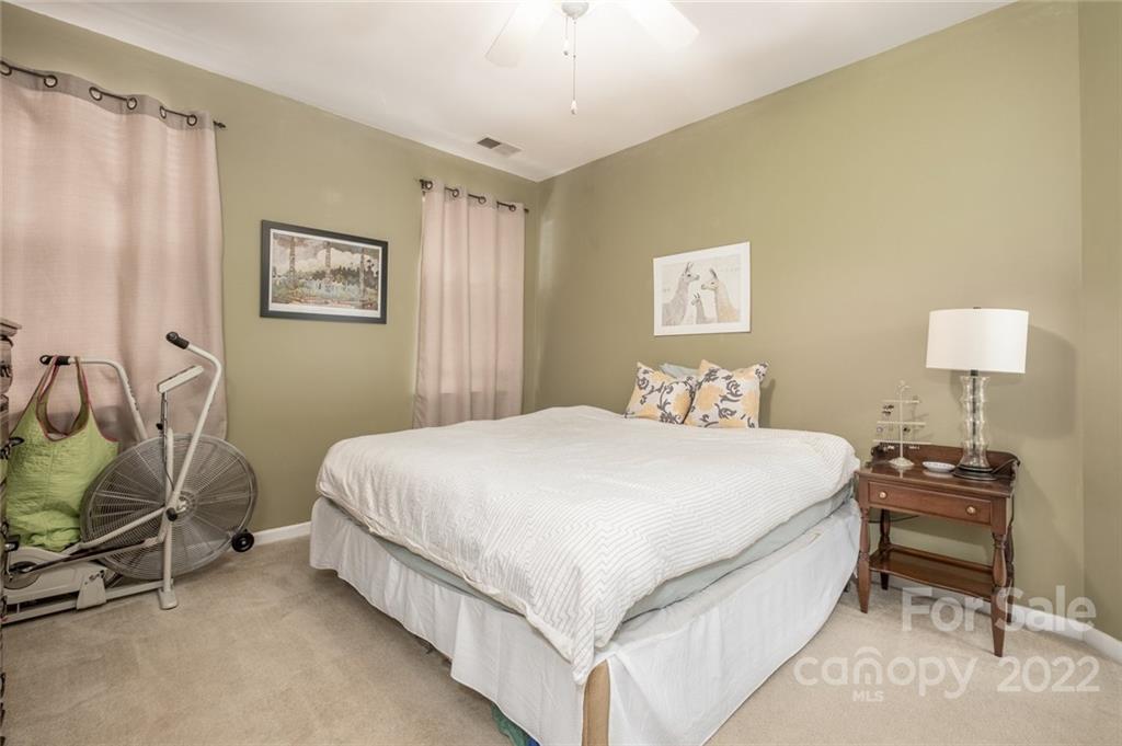 8010 Trotter Road Charlotte, NC 28216 - Photo 17 of 42 a bedroom with a bed and a chair