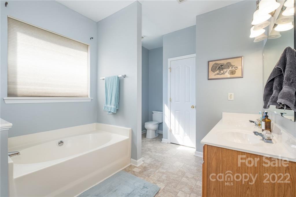 8010 Trotter Road Charlotte, NC 28216 - Photo 19 of 42 a white bath tub sitting next to a bathroom sink