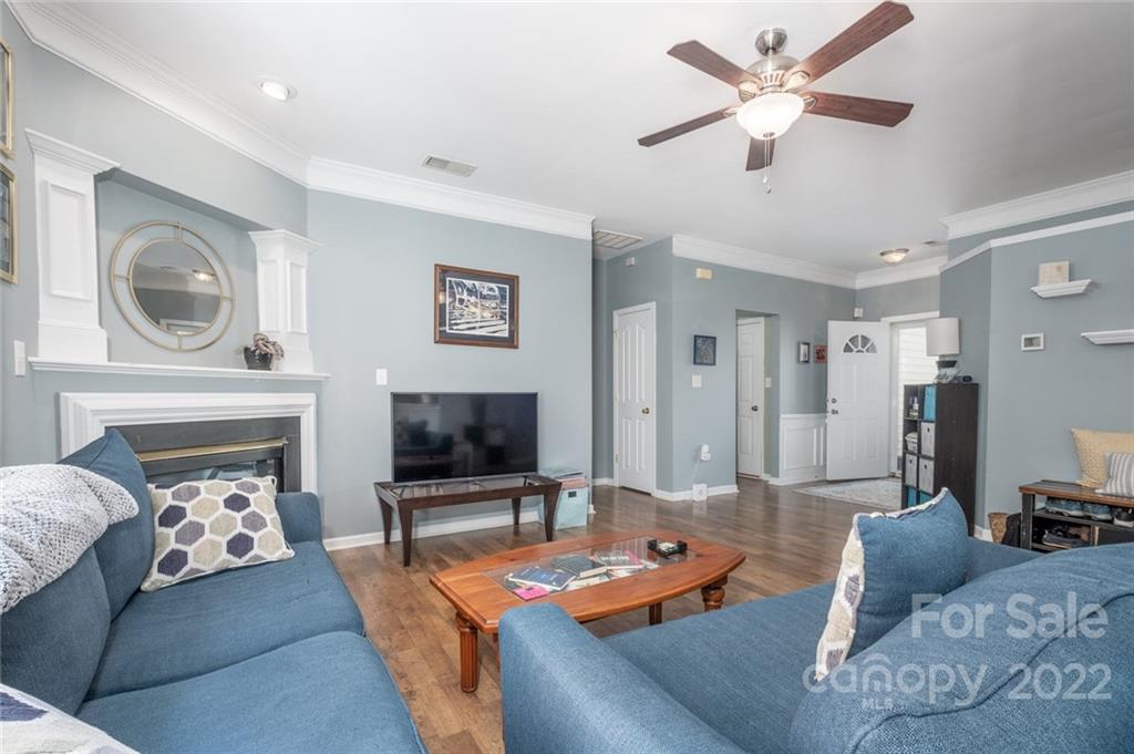 8010 Trotter Road Charlotte, NC 28216 - Photo 5 of 42 a living room with furniture a fireplace and a flat screen tv