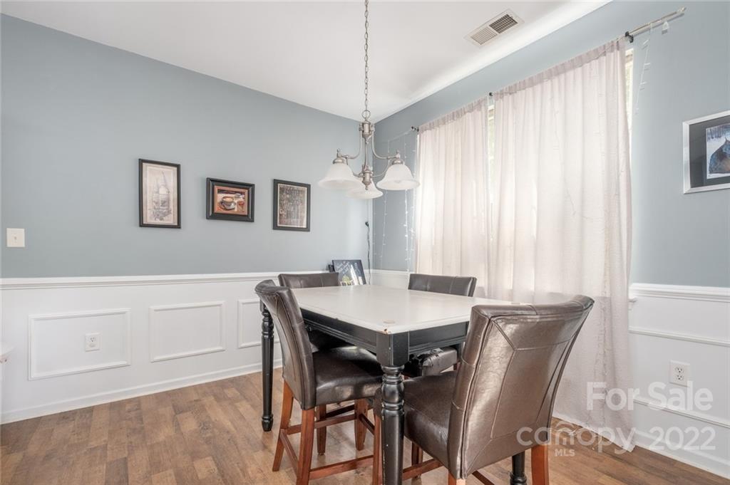 8010 Trotter Road Charlotte, NC 28216 - Photo 6 of 42 a view of a dining room with furniture window and wooden floor