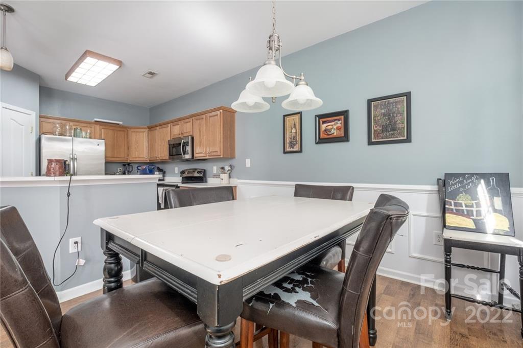 8010 Trotter Road Charlotte, NC 28216 - Photo 7 of 42 a view of kitchen with cabinets table and chairs