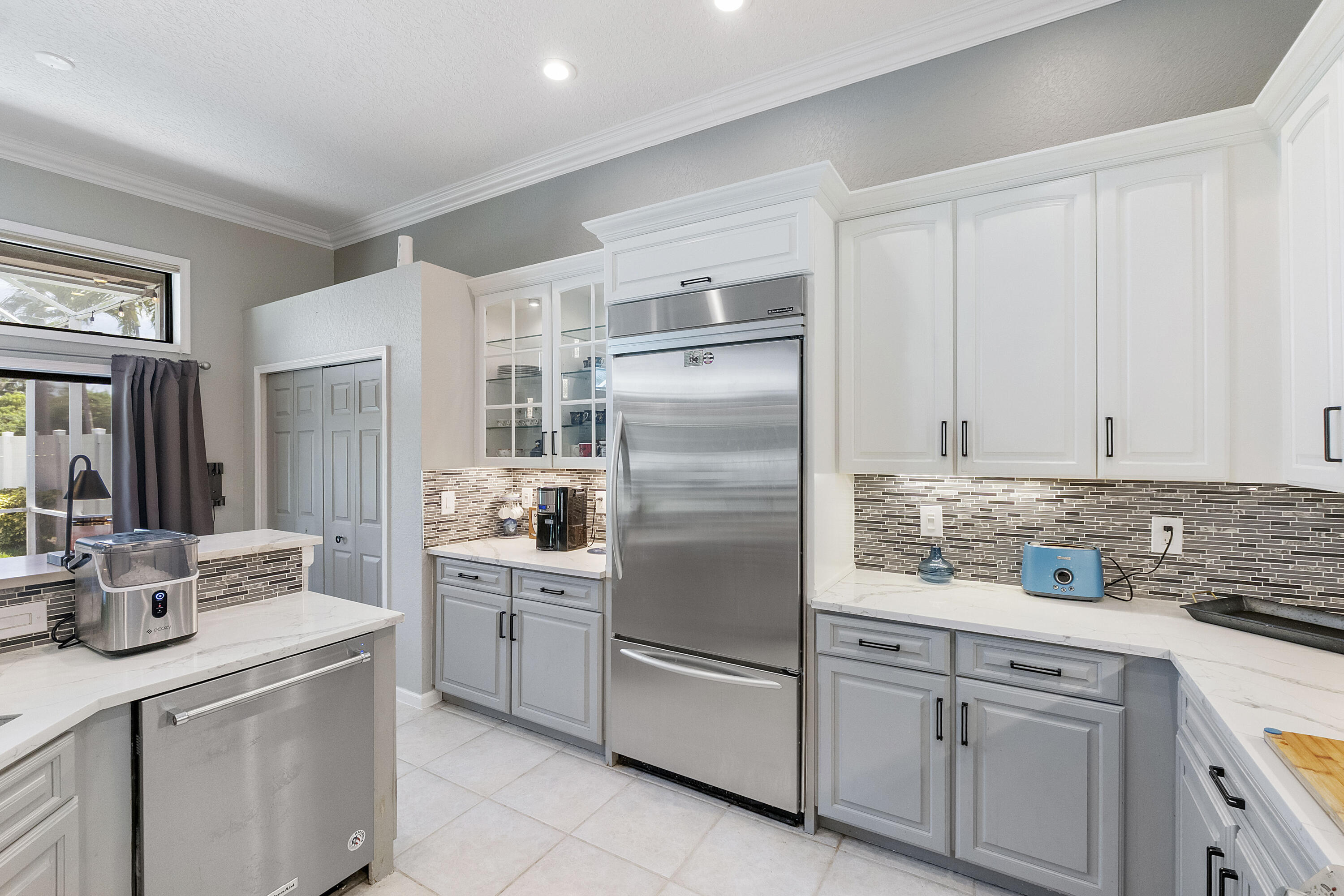 12328 St Simon Drive Boca Raton, FL 33428 - Photo 14 of 52 a kitchen with cabinets stainless steel appliances and a counter space