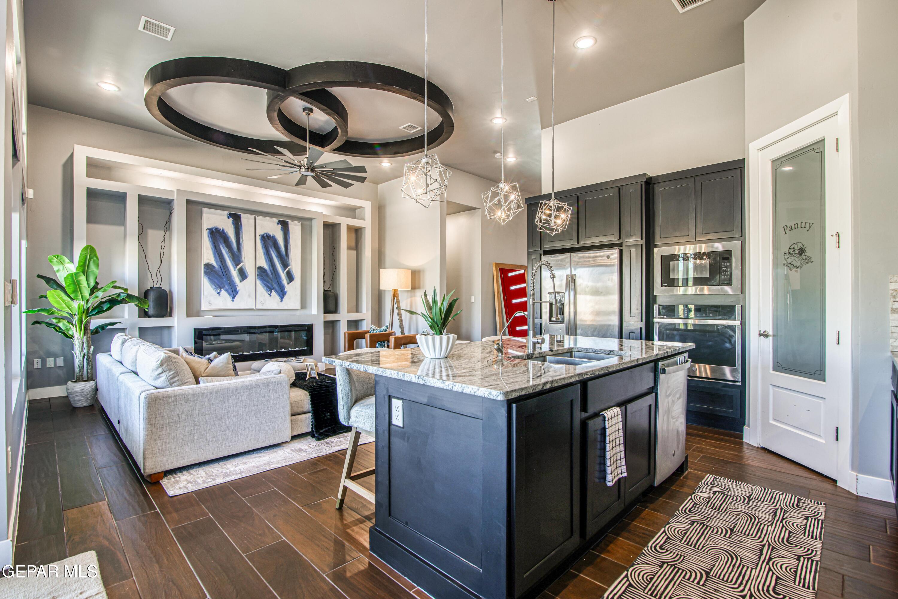 6716 Rio Haciendas El Paso, TX 79932 - Photo 15 of 65 a kitchen with cabinets a counter and chairs