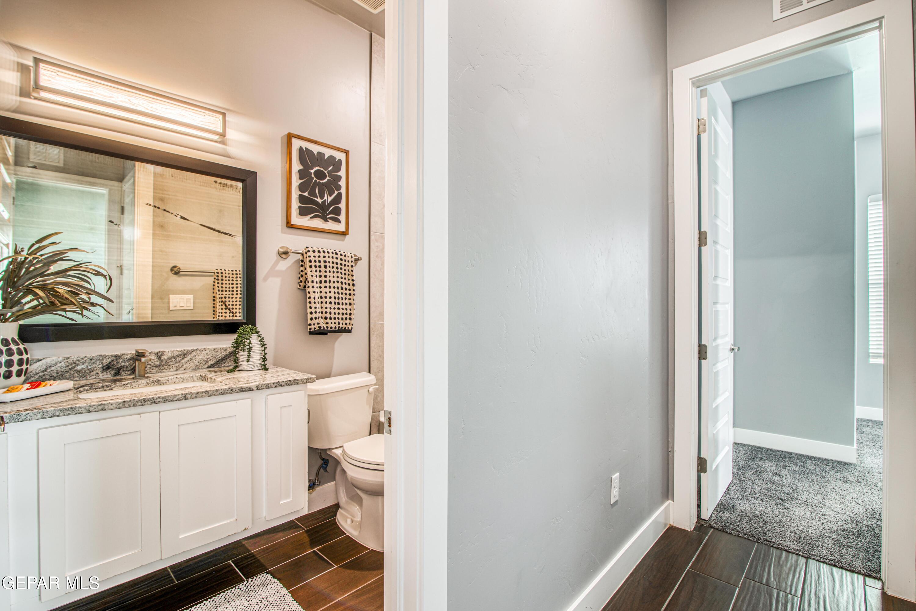 6716 Rio Haciendas El Paso, TX 79932 - Photo 30 of 65 a view of bathroom with a sink mirror toilet and next to a window