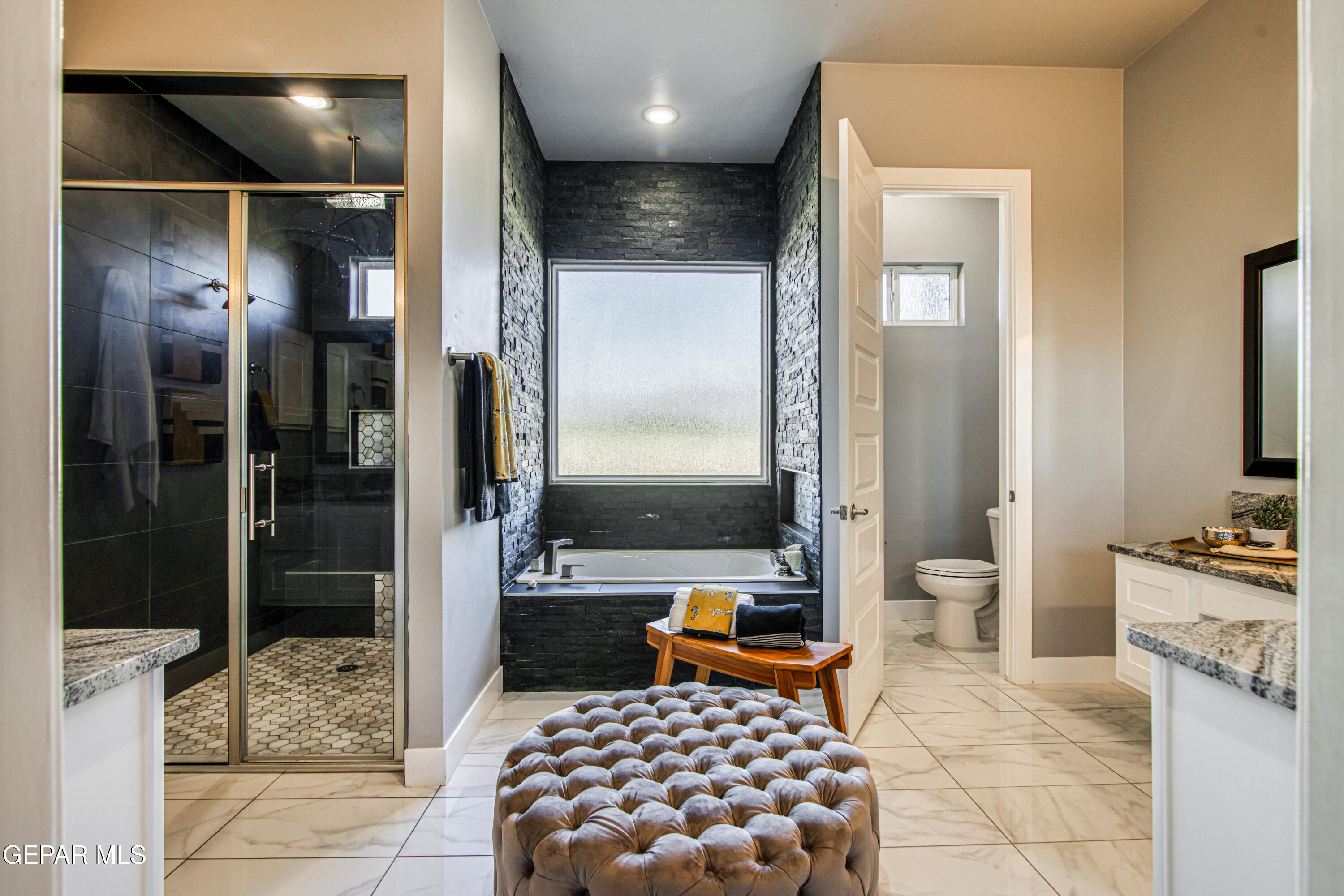 6716 Rio Haciendas El Paso, TX 79932 - Photo 38 of 65 a bathroom with a tub a mirror and shower