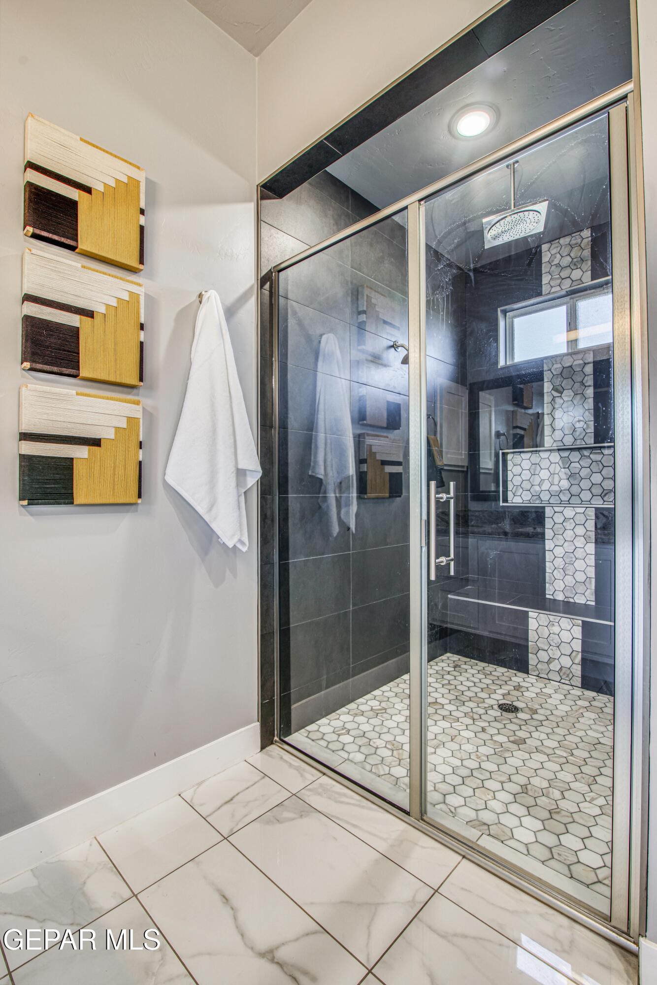 6716 Rio Haciendas El Paso, TX 79932 - Photo 46 of 65 a bathroom with a glass shower door and a sink
