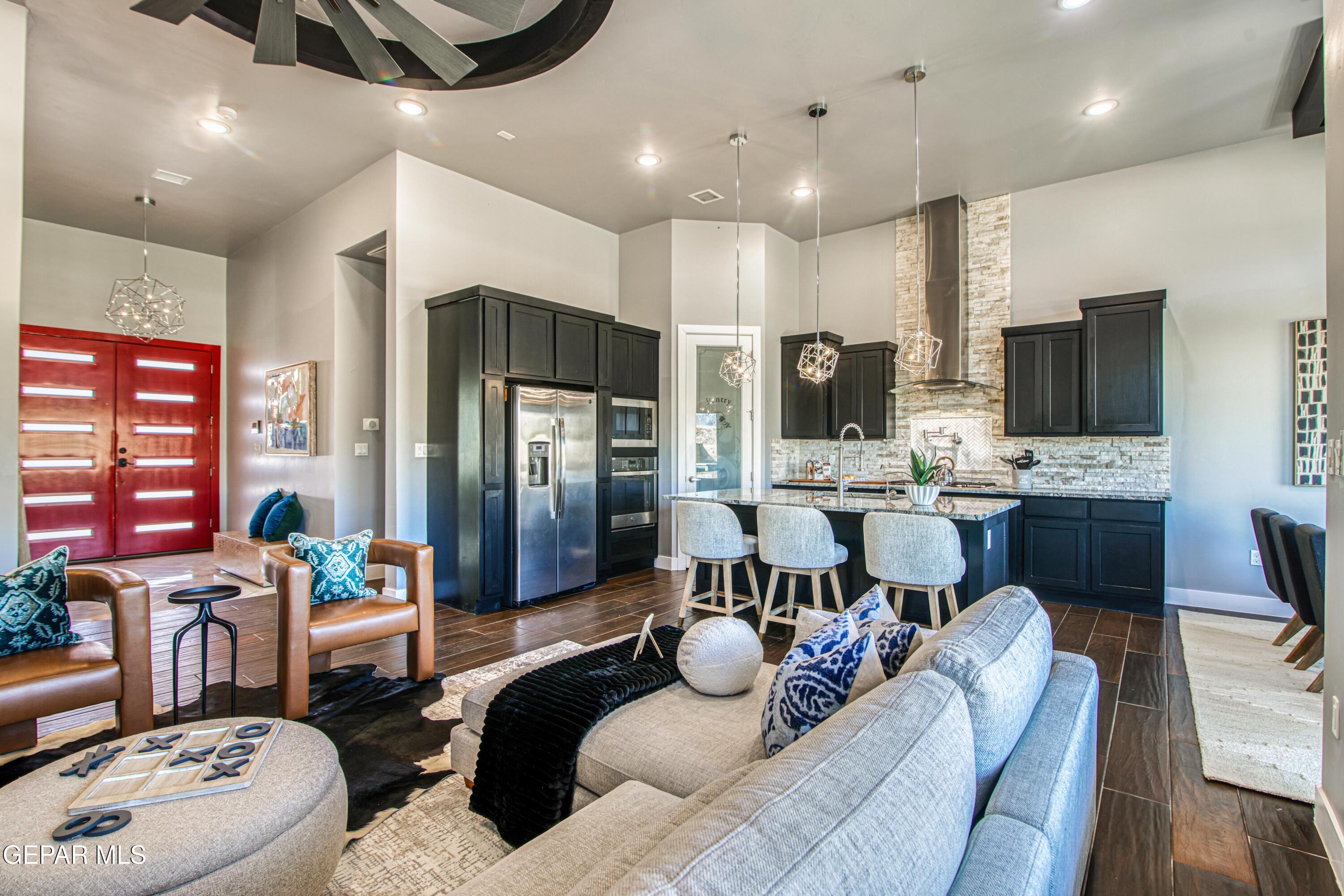 6716 Rio Haciendas El Paso, TX 79932 - Photo 10 of 65 a living room with fireplace furniture and a flat screen tv