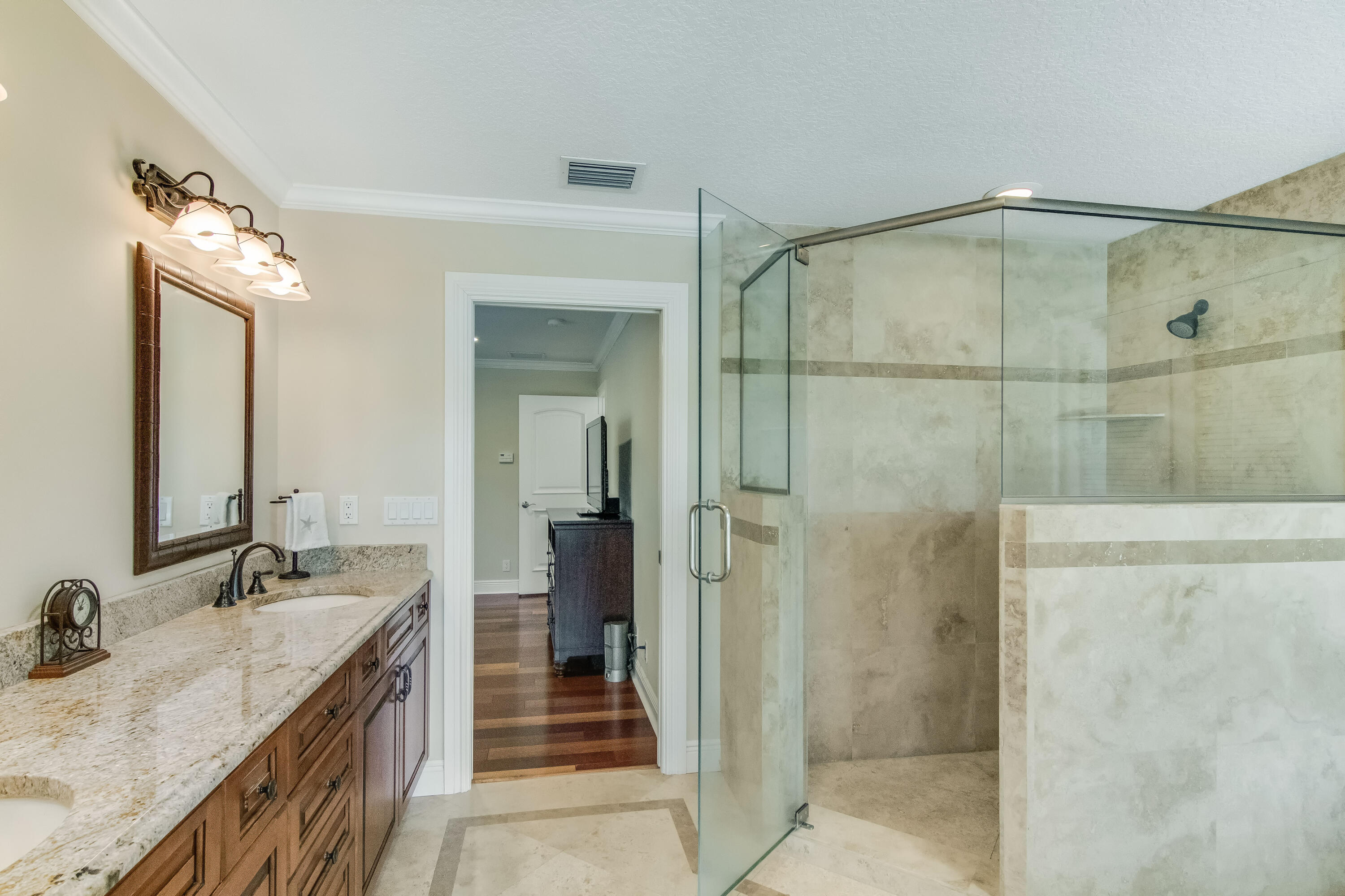 936 Dolphin Drive Jupiter, FL 33458 - Photo 17 of 72 a bathroom with a granite countertop sink a mirror and shower