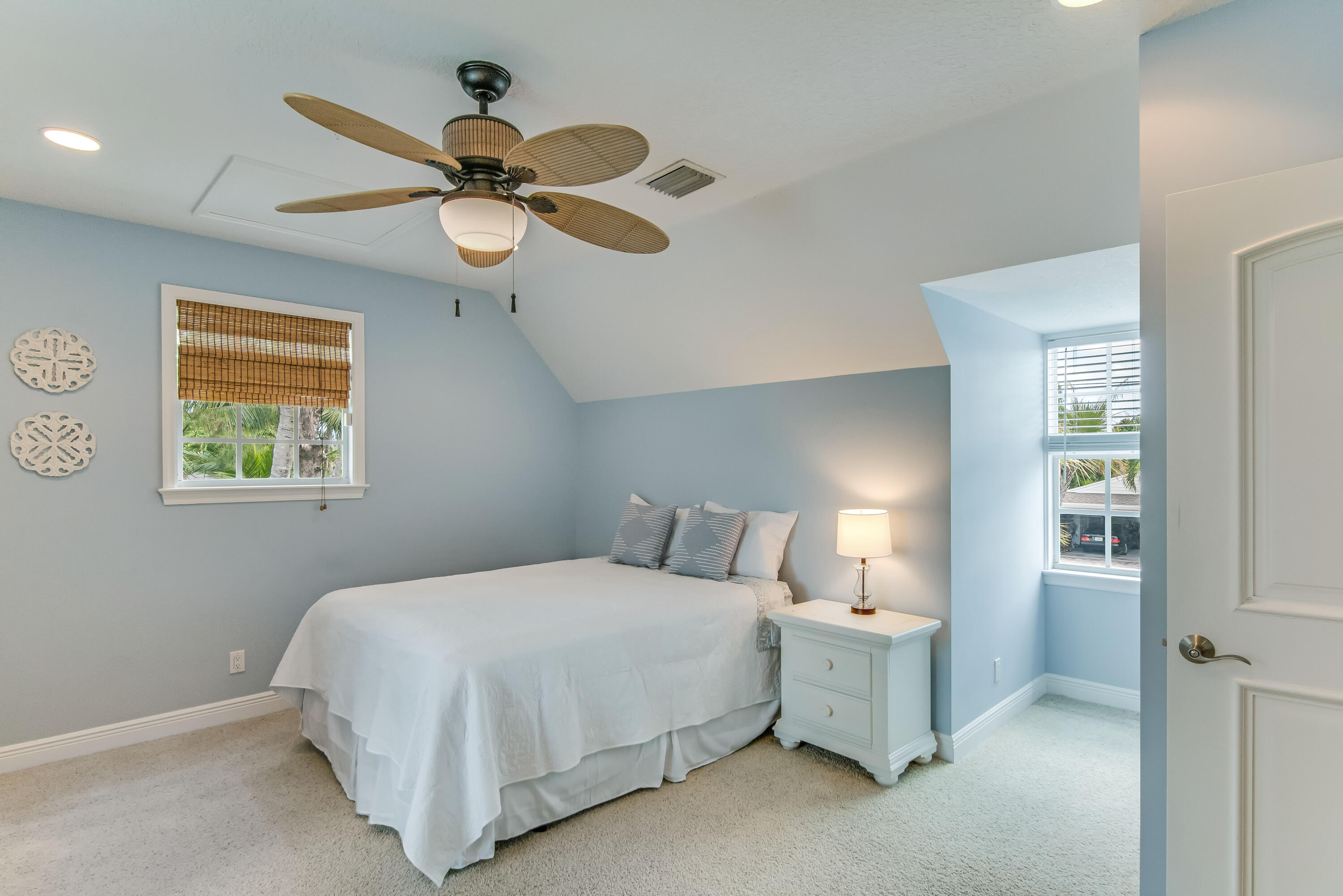 936 Dolphin Drive Jupiter, FL 33458 - Photo 30 of 72 a bedroom with a bed and a chandelier