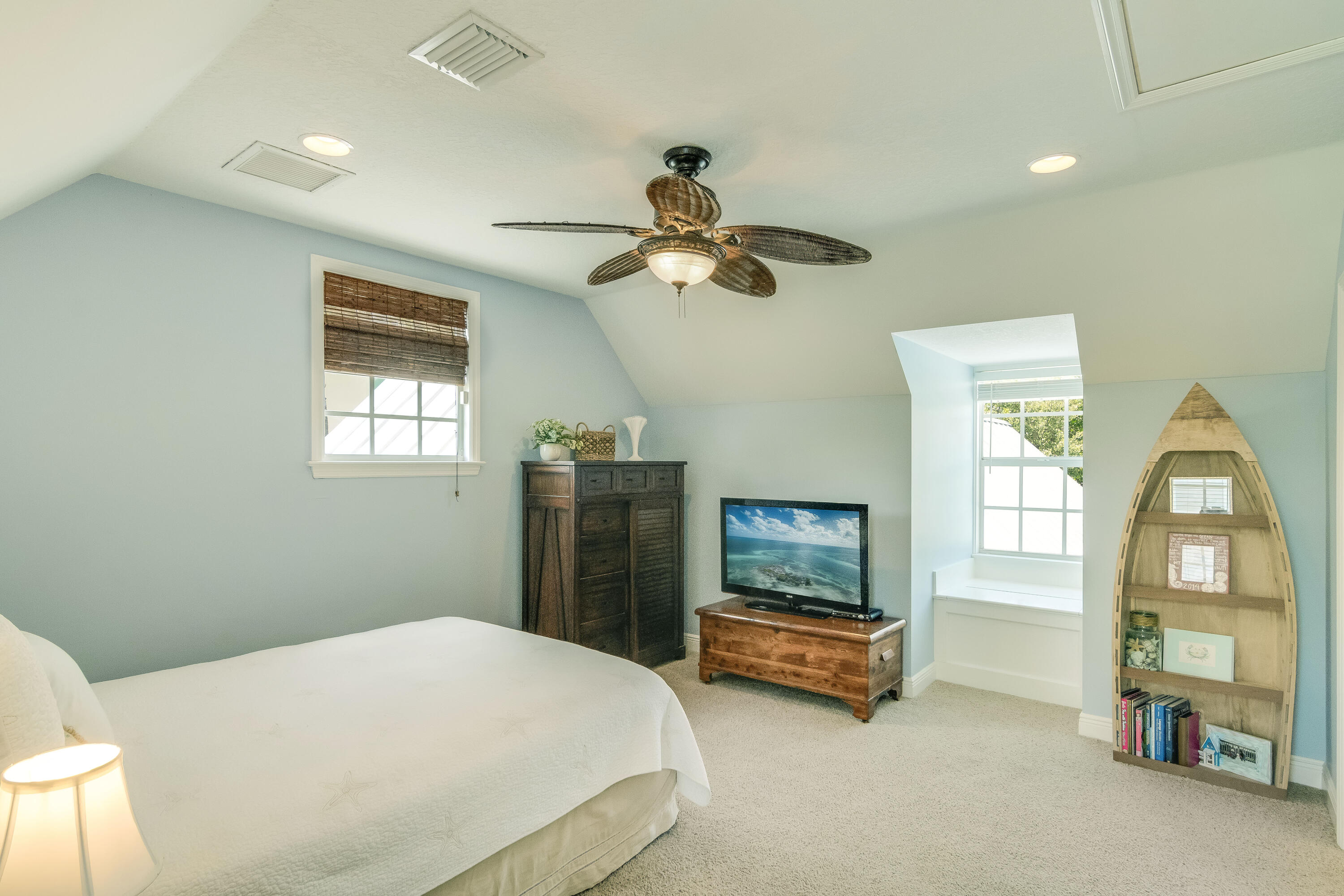 936 Dolphin Drive Jupiter, FL 33458 - Photo 36 of 72 a bedroom with a bed and a chandelier