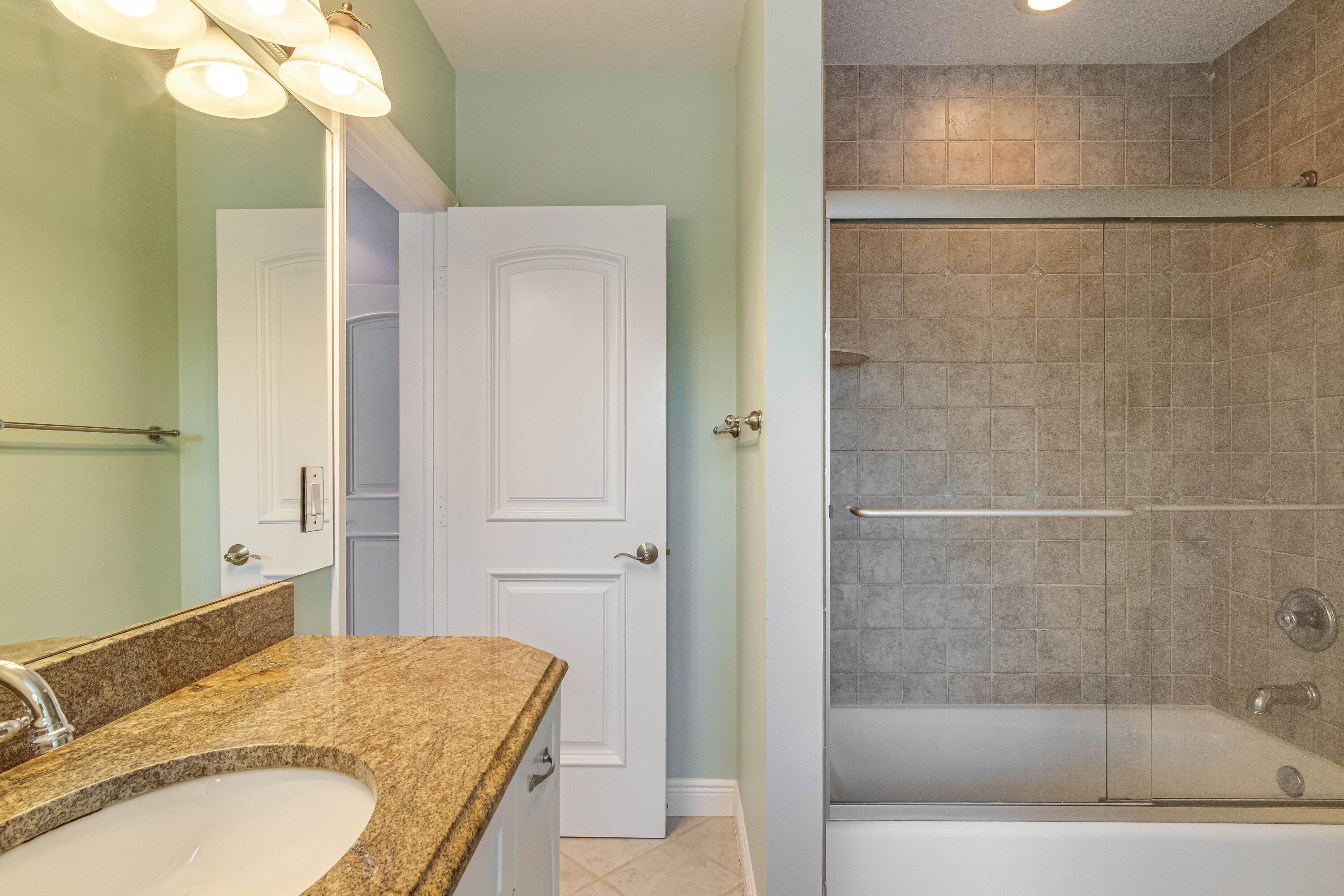 936 Dolphin Drive Jupiter, FL 33458 - Photo 44 of 72 a bathroom with a granite countertop sink and a mirror