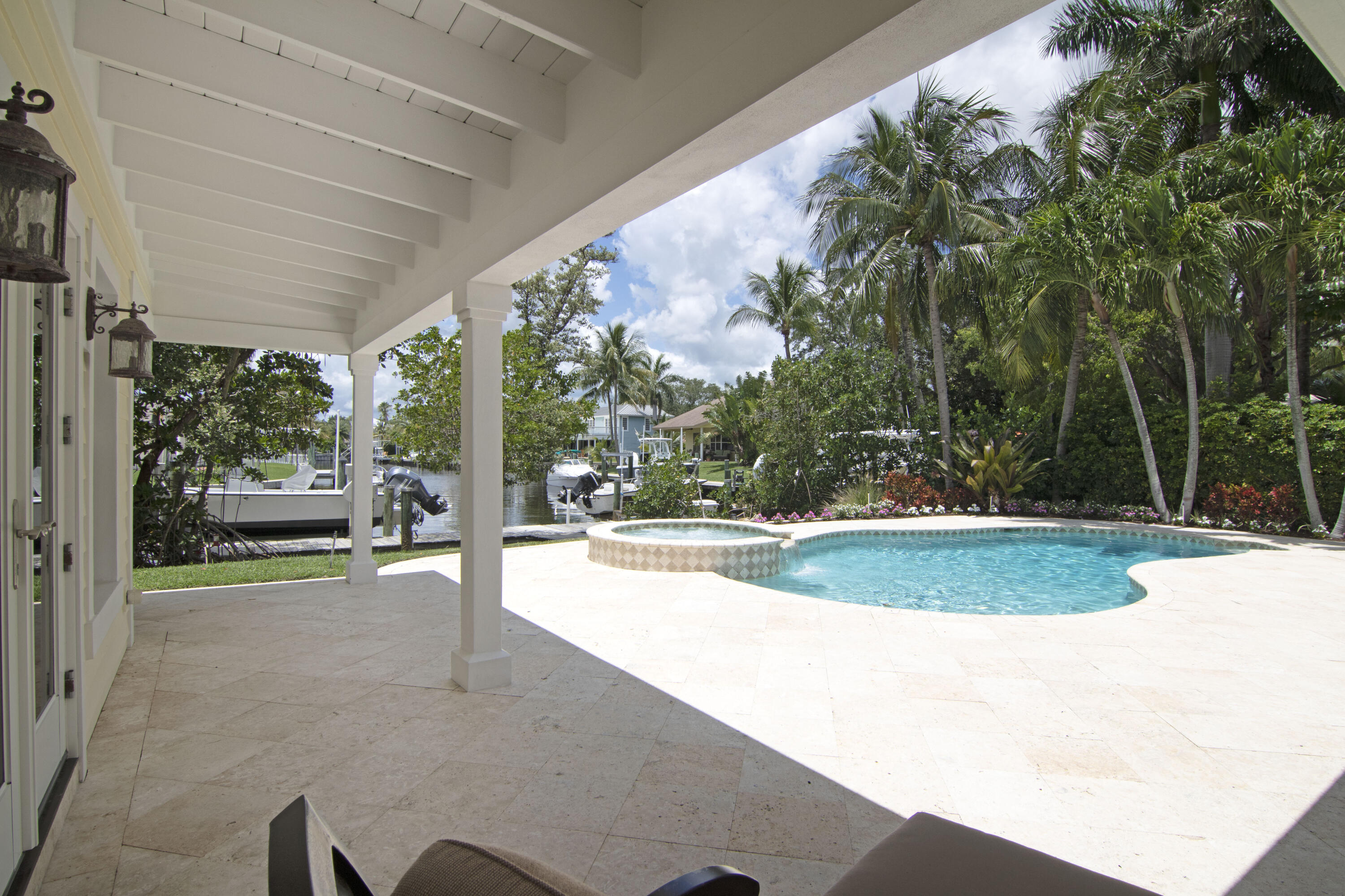 936 Dolphin Drive Jupiter, FL 33458 - Photo 48 of 72 a view of a swimming pool with an outdoor seating