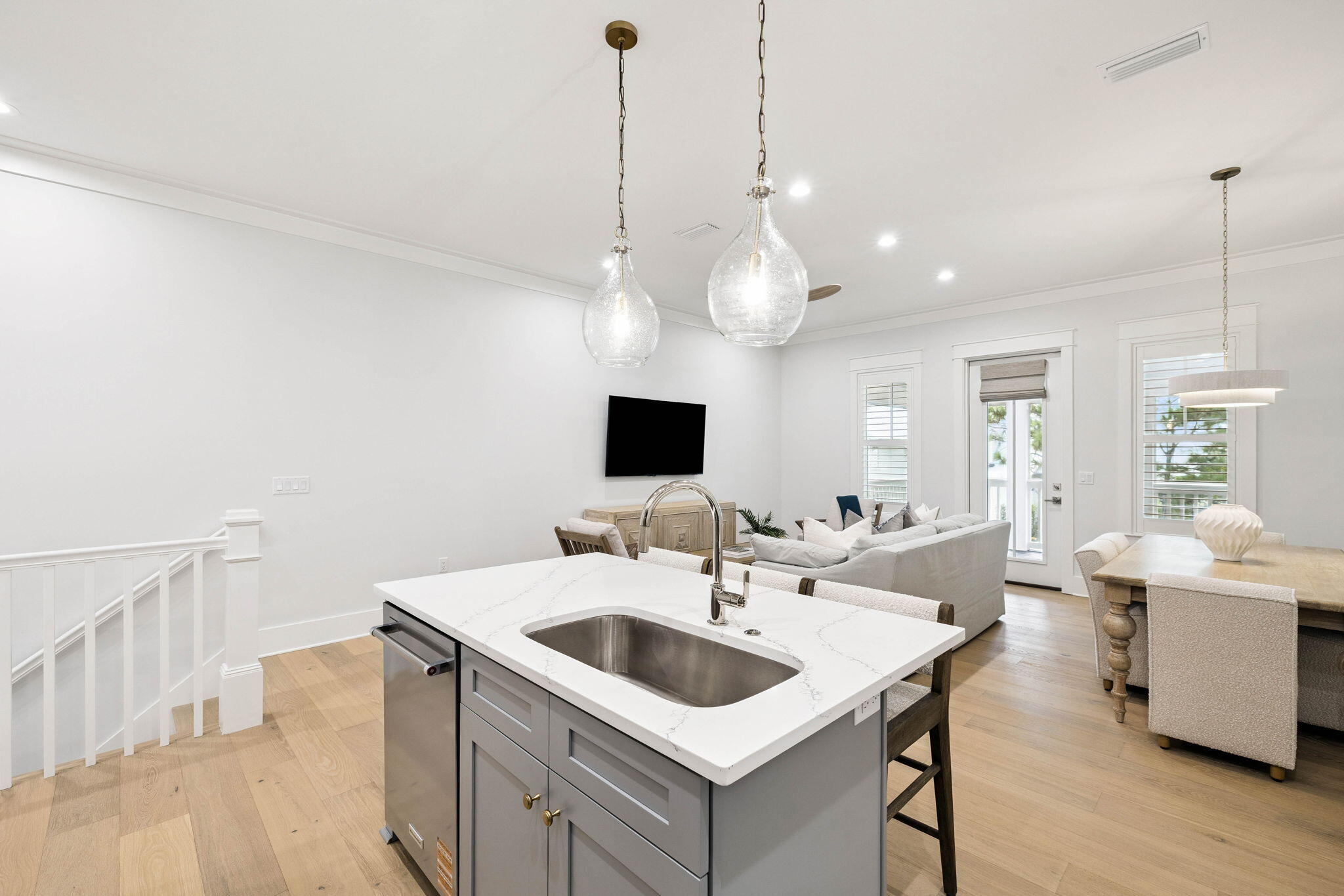45 Grove Townhomes Place, Unit 105 Santa Rosa Beach, FL 32459 - Photo 11 of 36 a kitchen with a sink a counter top space and living room view